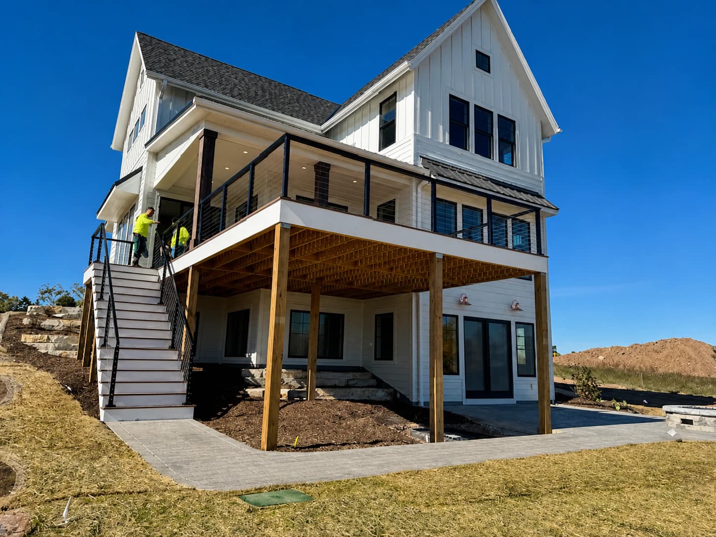 Farmhouse-style custom home with new deck and exterior lighting, wired by Greatland Electric in Southeast Wisconsin