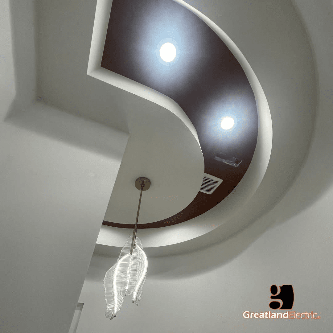 Curved multi-level ceiling with recessed downlights and a feather-shaped pendant, wired by Greatland Electric