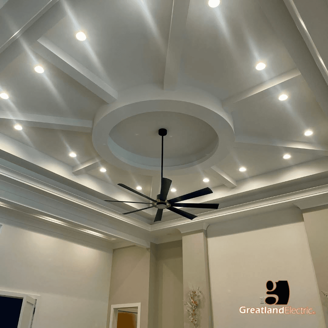Coffered ceiling with radial beams, recessed lights, and a black ceiling fan in a finished custom home
